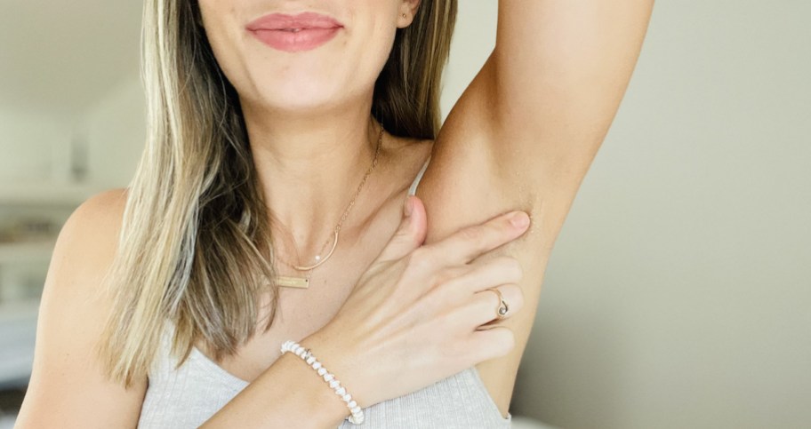 close up of woman's armpit with finger touching skin