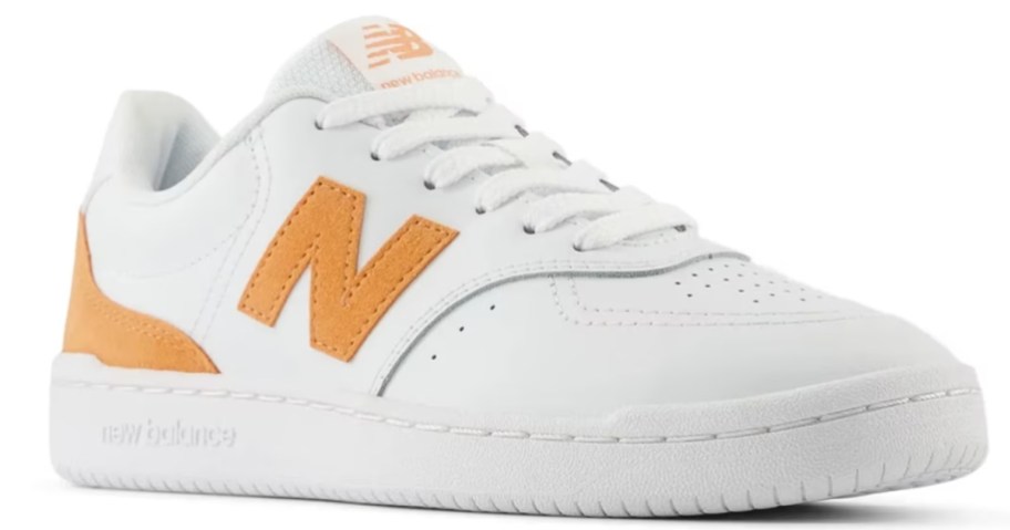 a women's white and orange New Balance sneaker