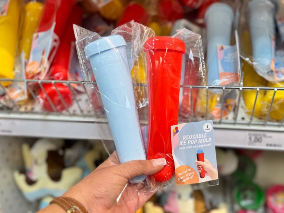 A person holding blue and pink ice pop molds