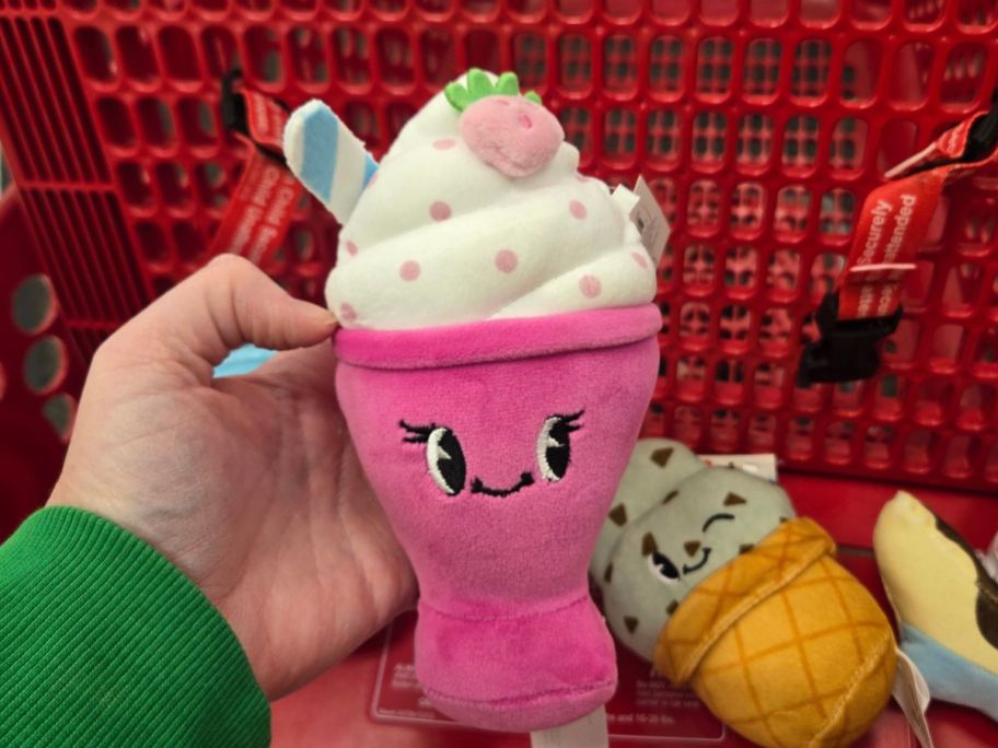 pink shake plushie in hand in store