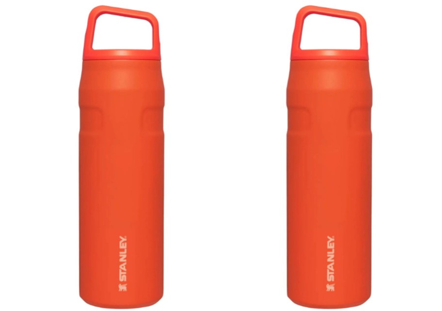 two orange stanley tumblers with their lids