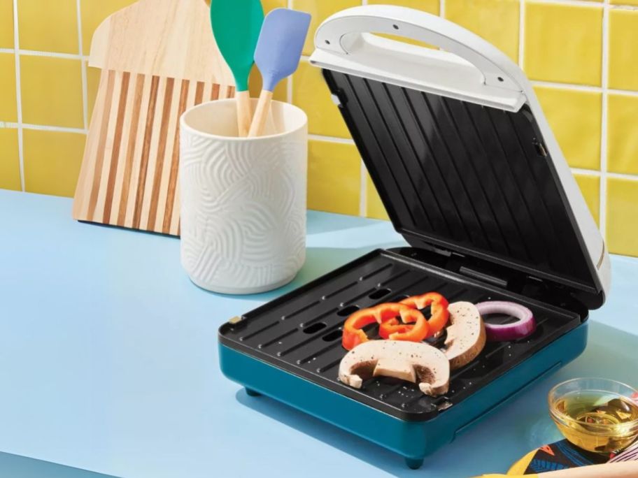 Tabitha Brown Non-Stick Indoor Grill on counter with vegetables on it