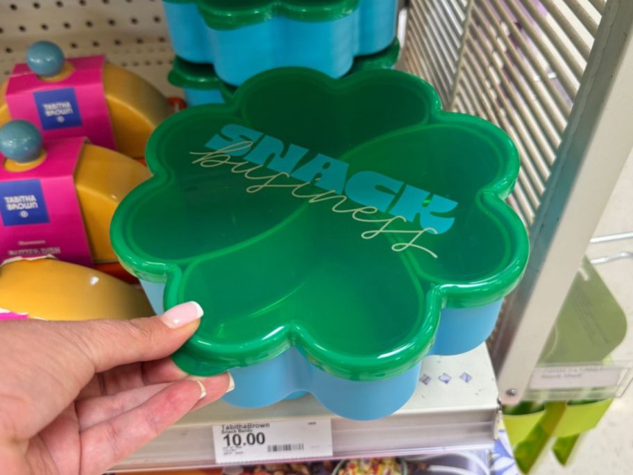 green and blue Tabitha Brown Snack Bento in hand in store